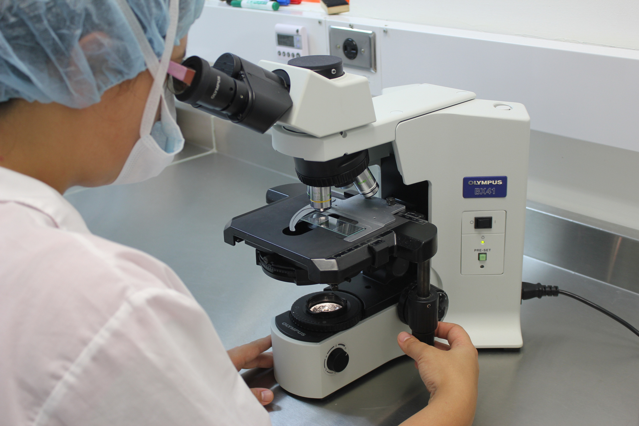 Lab Technician Using Microscope